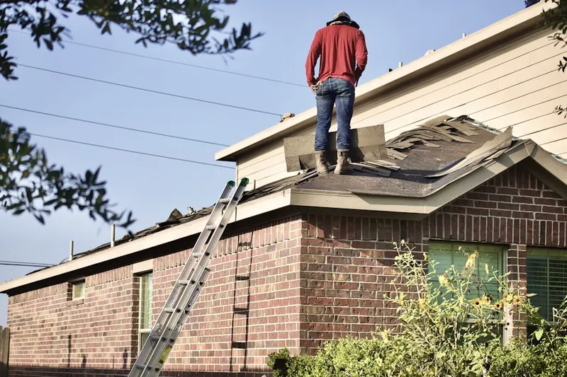 Professional roofer working on a residential roof in Topton